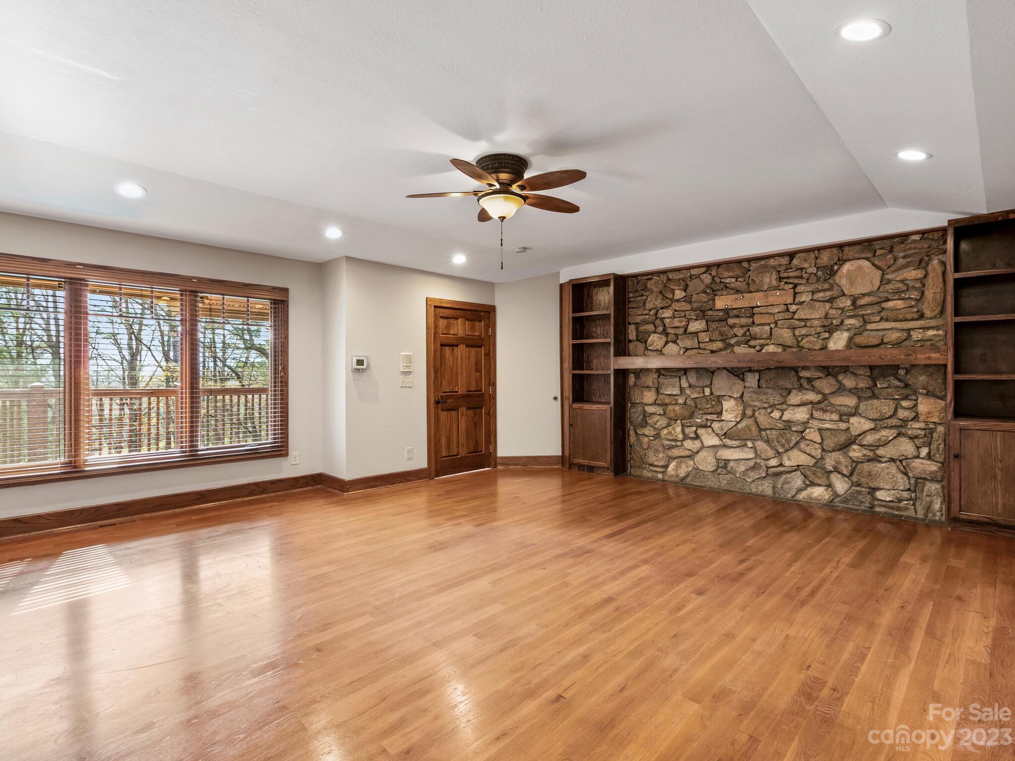 122 Emmas Grove Road Fletcher, NC 28732 - Photo 14 of 48 a view of an empty room with a window and wooden floor