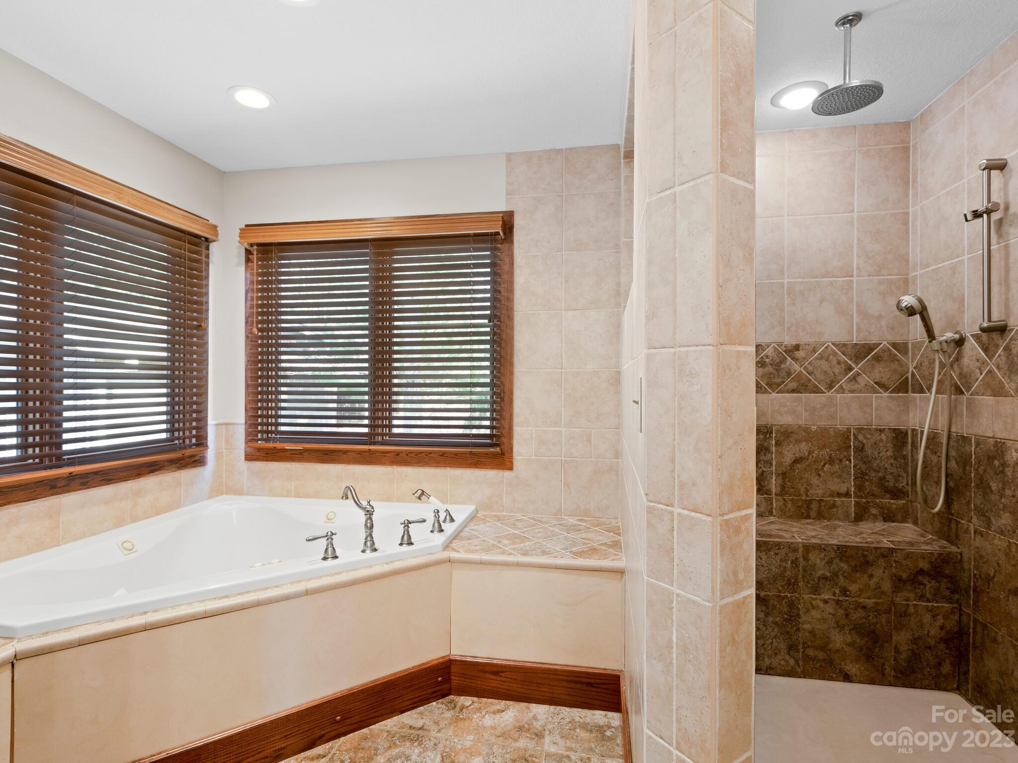 122 Emmas Grove Road Fletcher, NC 28732 - Photo 16 of 48 a bathroom with a tub sink and mirror