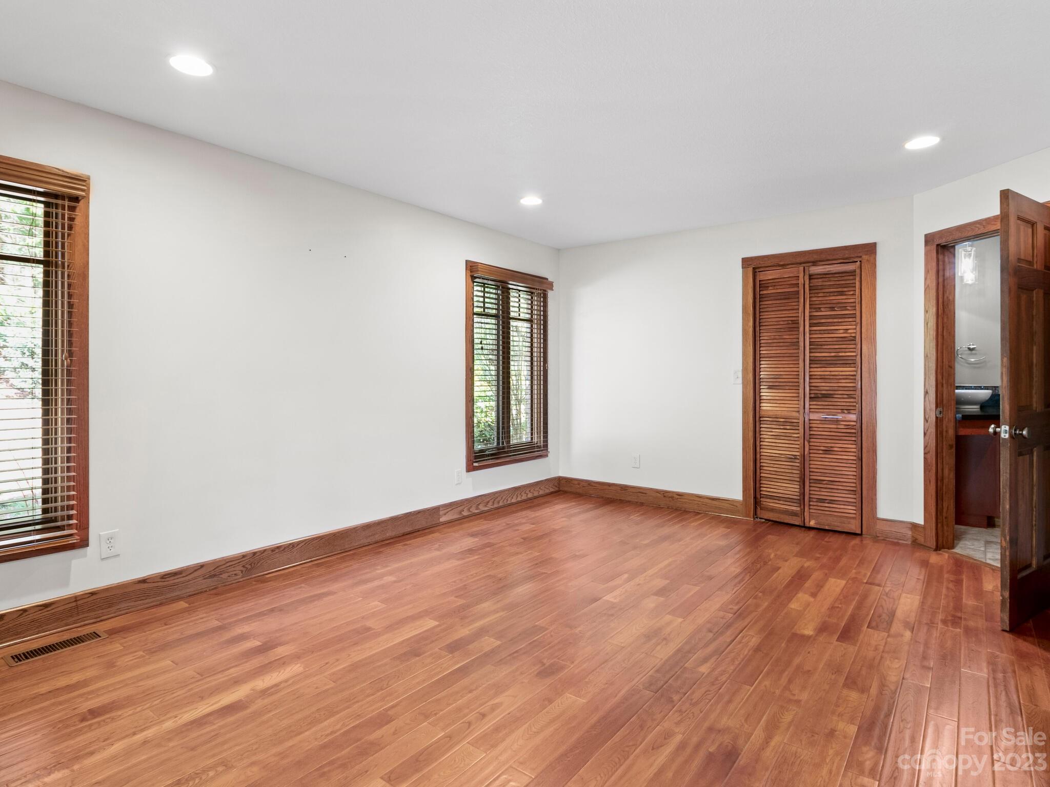 122 Emmas Grove Road Fletcher, NC 28732 - Photo 20 of 48 a view of an empty room with wooden floor and a window