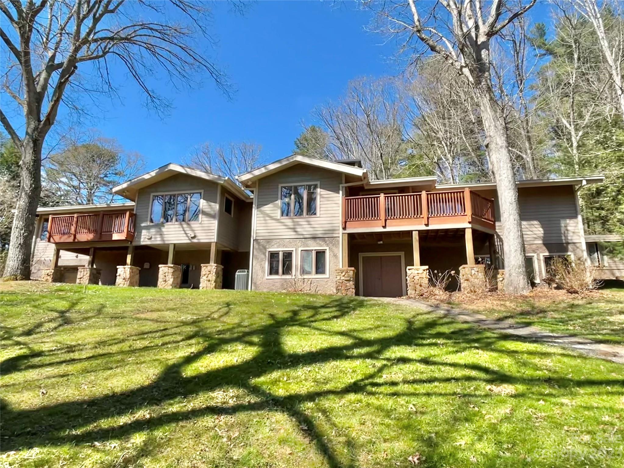 122 Emmas Grove Road Fletcher, NC 28732 - Photo 2 of 48 a front view of a house with a garden