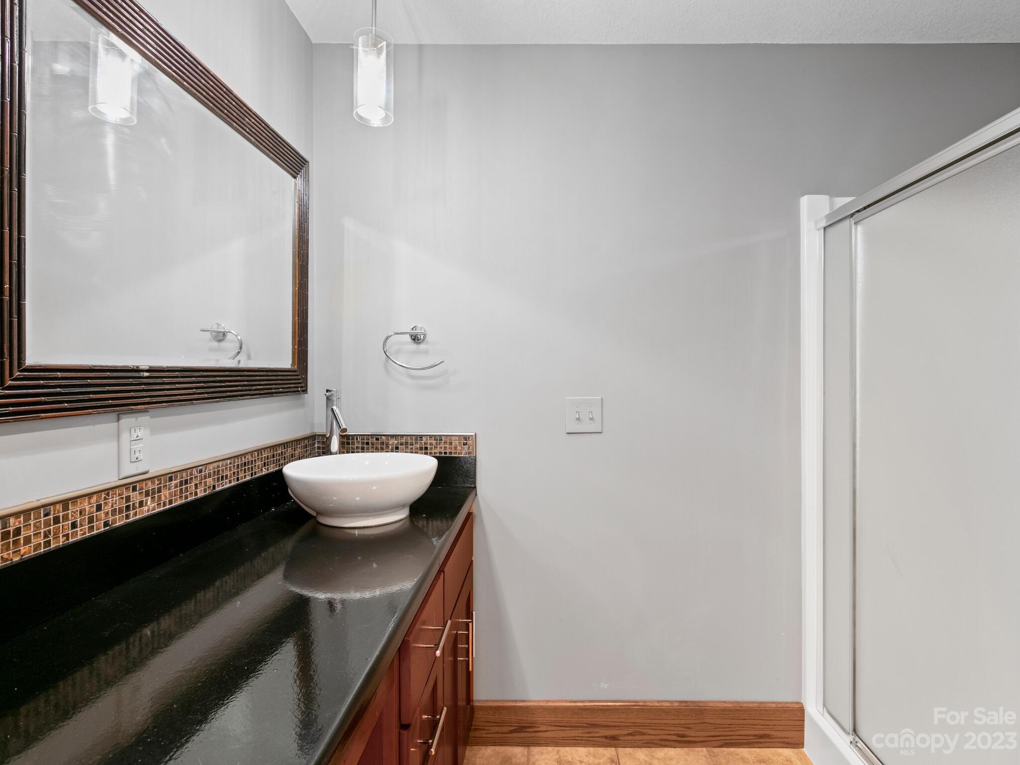 122 Emmas Grove Road Fletcher, NC 28732 - Photo 21 of 48 a bathroom with a sink and a mirror