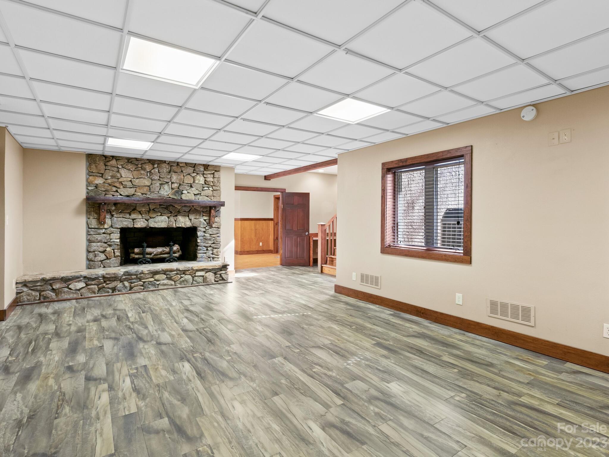 122 Emmas Grove Road Fletcher, NC 28732 - Photo 23 of 48 a view of empty room with wooden floor and fireplace