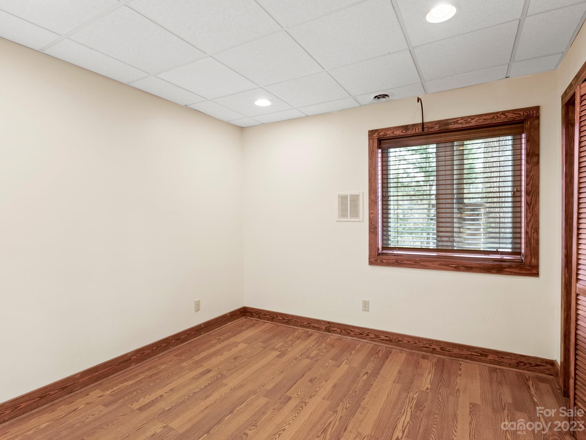 122 Emmas Grove Road Fletcher, NC 28732 - Photo 25 of 48 a view of empty room with wooden floor and fan
