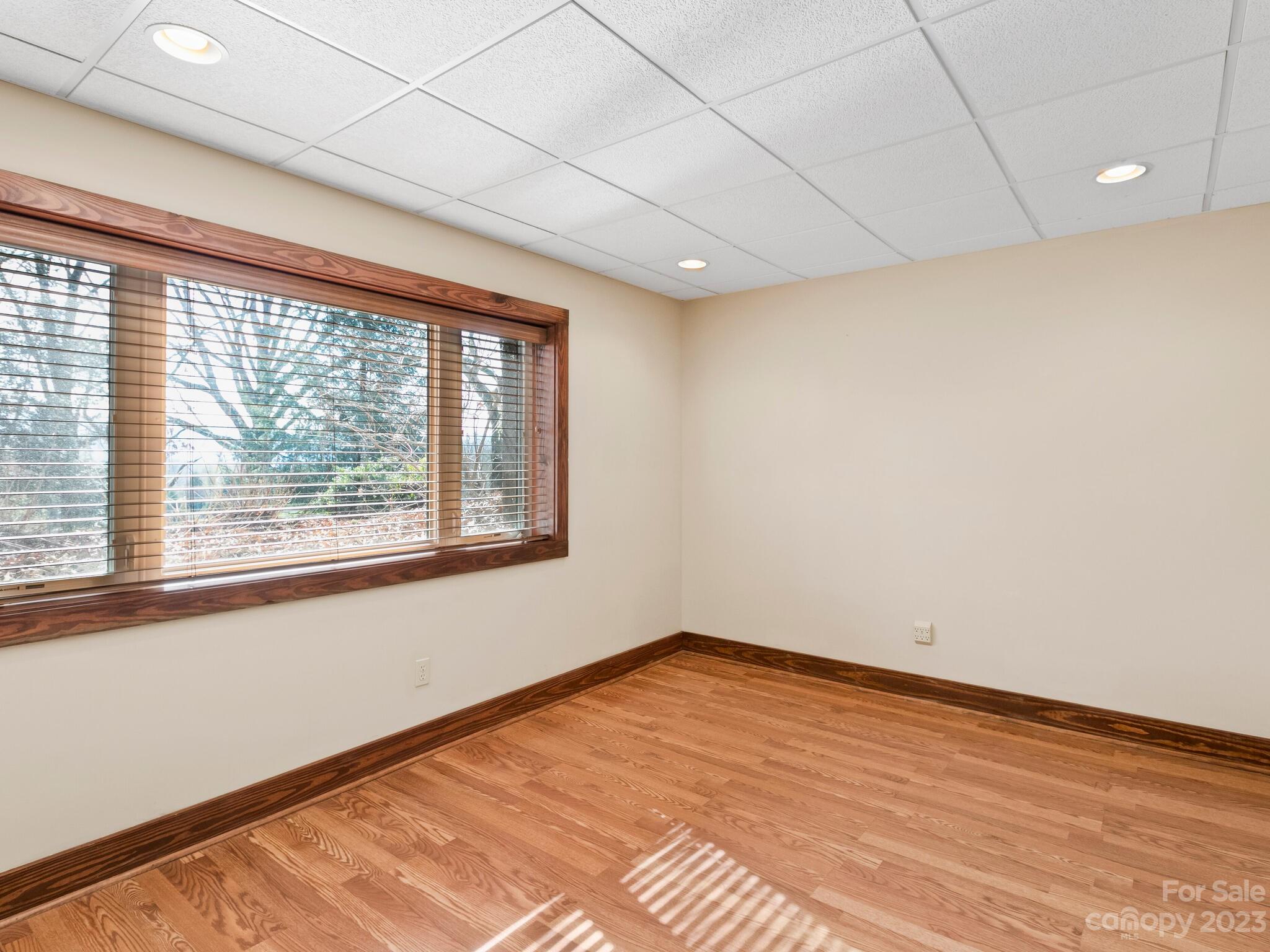 122 Emmas Grove Road Fletcher, NC 28732 - Photo 26 of 48 a view of empty room with wooden floor and fan