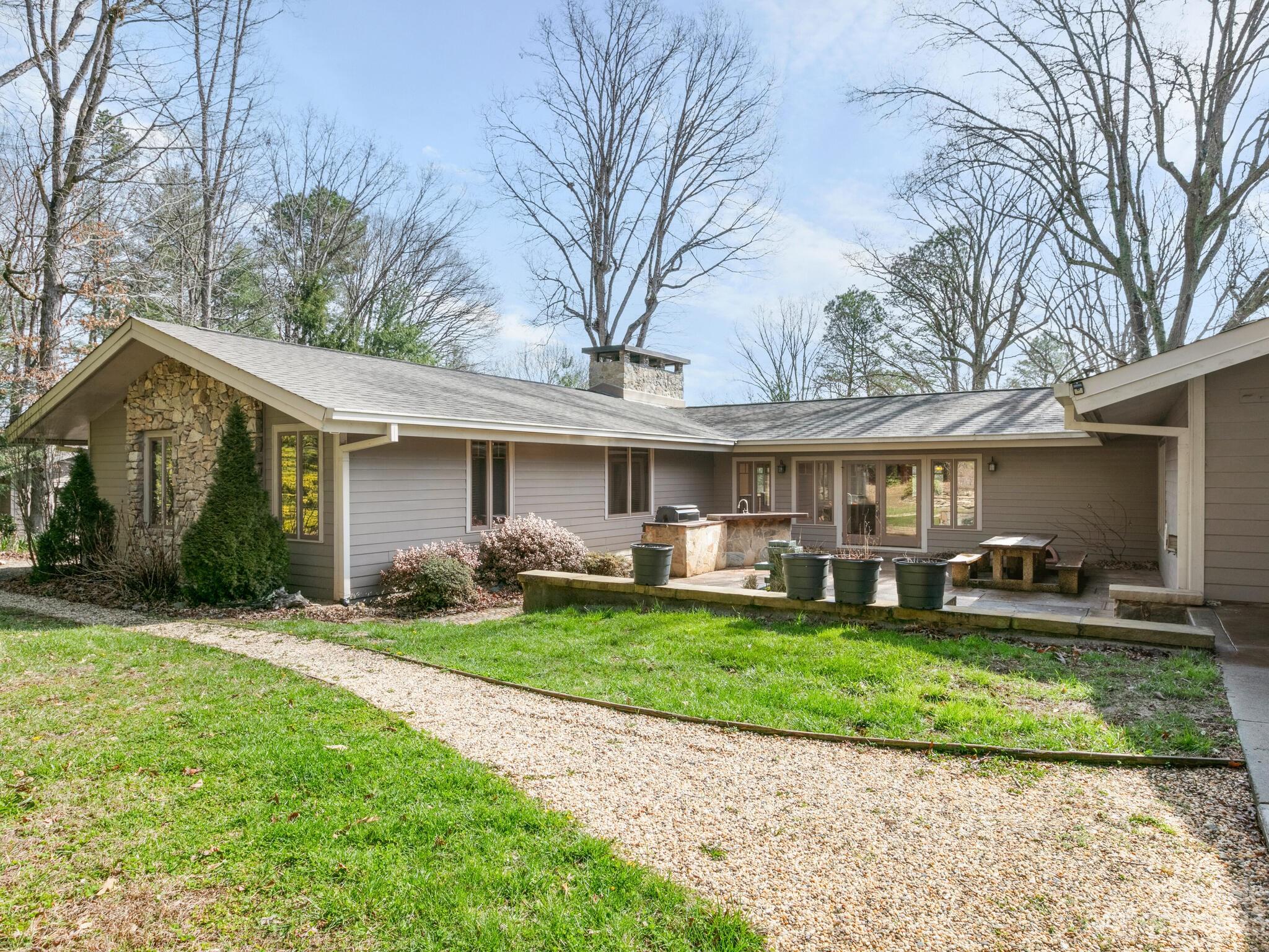 122 Emmas Grove Road Fletcher, NC 28732 - Photo 33 of 48 a front view of a house with a garden and trees