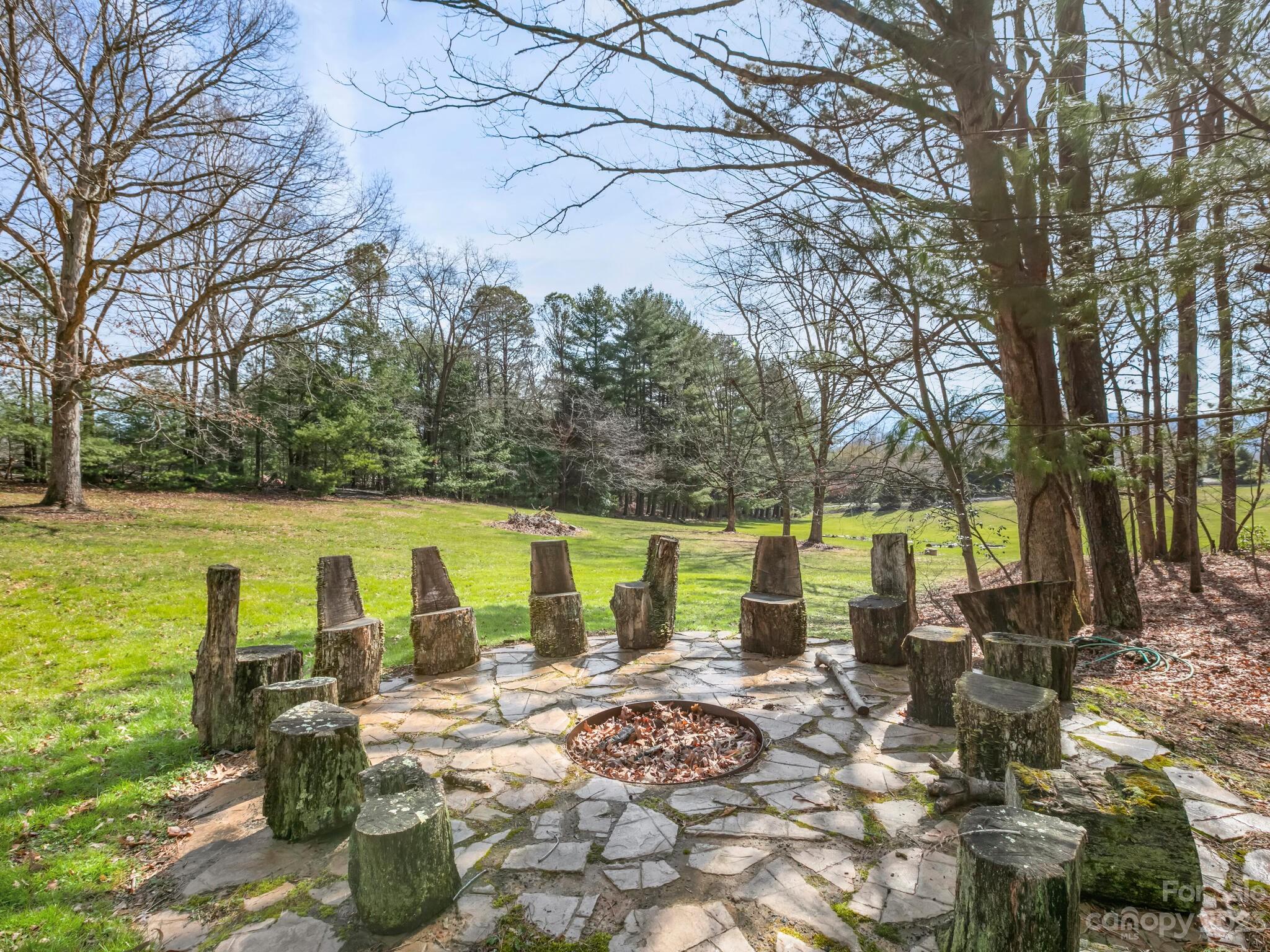 122 Emmas Grove Road Fletcher, NC 28732 - Photo 34 of 48 a view of a lake with a patio