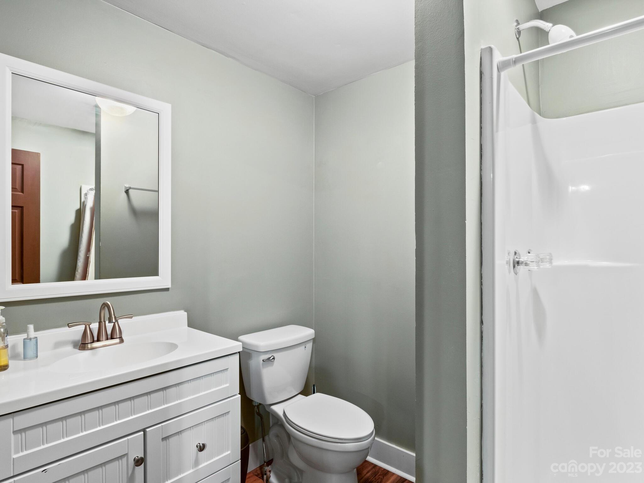 122 Emmas Grove Road Fletcher, NC 28732 - Photo 37 of 48 a bathroom with a granite countertop sink vanity mirror and toilet