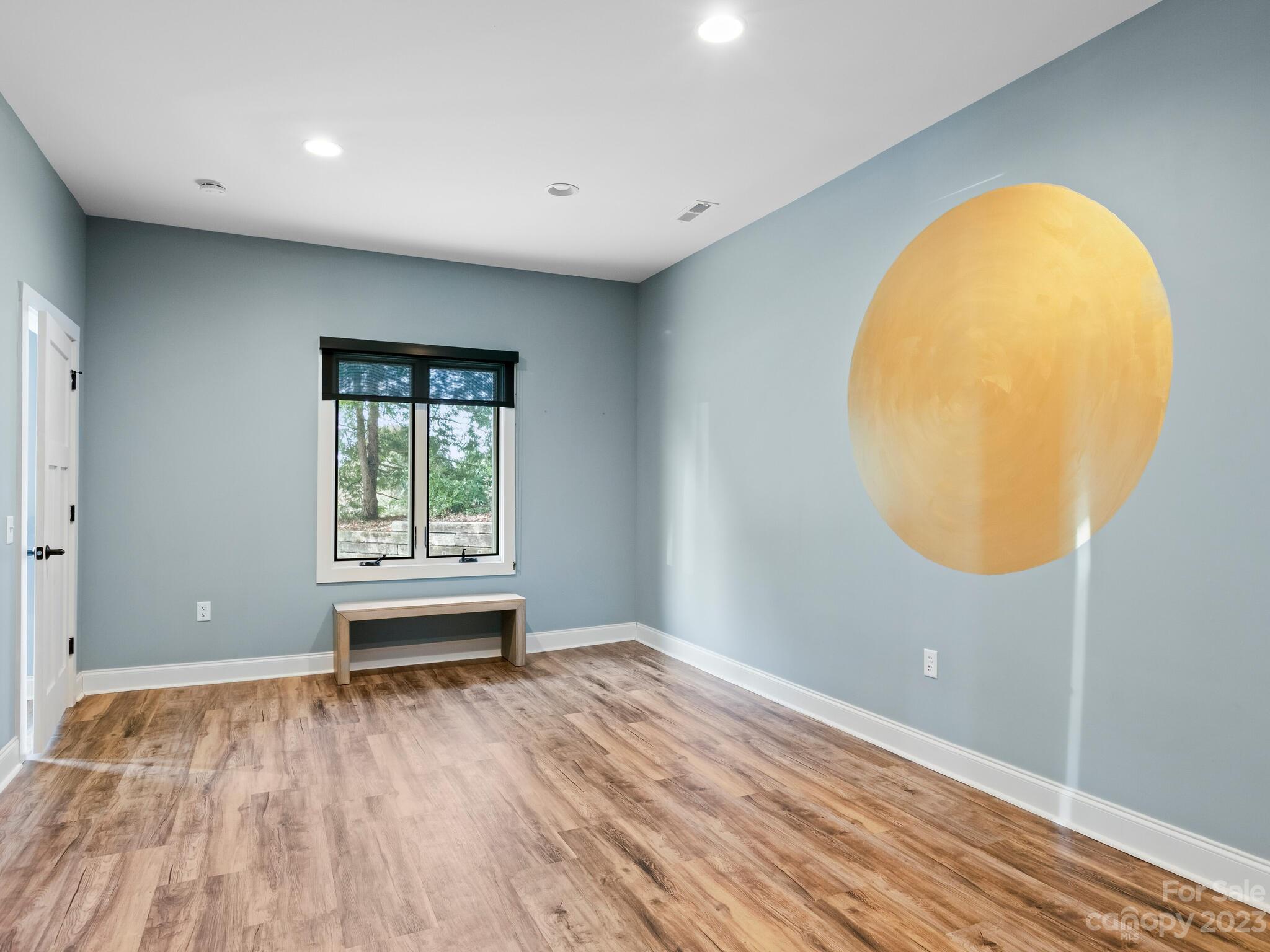 122 Emmas Grove Road Fletcher, NC 28732 - Photo 41 of 48 an empty room with wooden floor and a window