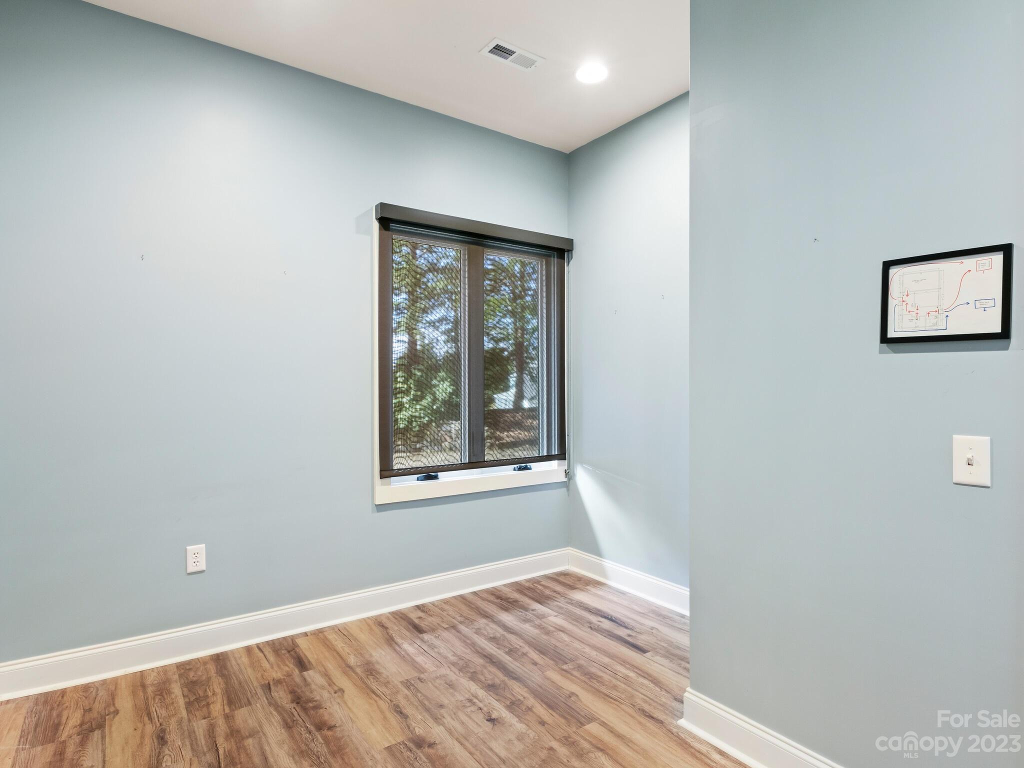 122 Emmas Grove Road Fletcher, NC 28732 - Photo 43 of 48 a view of an empty room with wooden floor and a window