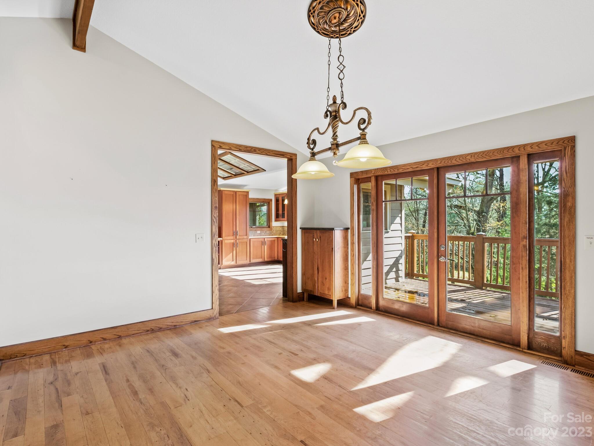 122 Emmas Grove Road Fletcher, NC 28732 - Photo 7 of 48 a view of a livingroom with wooden floor and chandelier