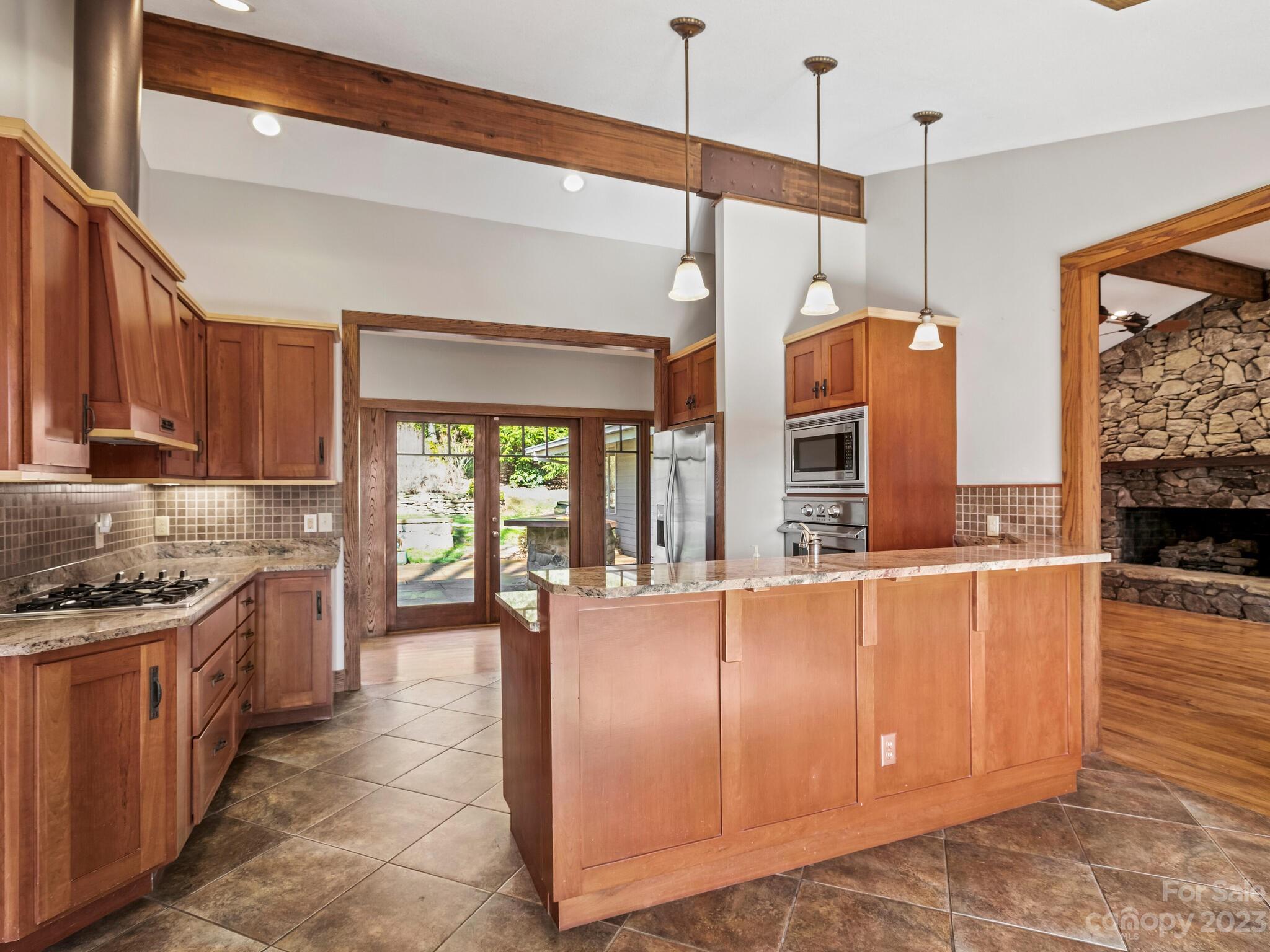 122 Emmas Grove Road Fletcher, NC 28732 - Photo 9 of 48 a large kitchen with stainless steel appliances granite countertop a stove a sink and a refrigerator