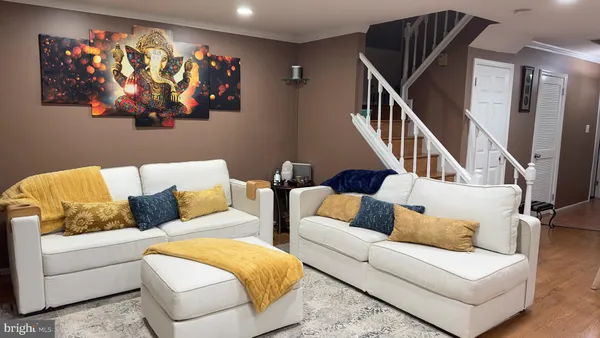 a living room with furniture and wall painting