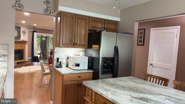 a kitchen with stainless steel appliances granite countertop a refrigerator and a stove top oven