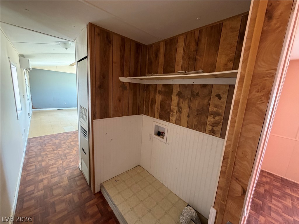 4360 Retread Road Pahrump, NV 89048 - Photo 12 of 19 Wood paneling and integrated shelving define this dedicated laundry alcove.