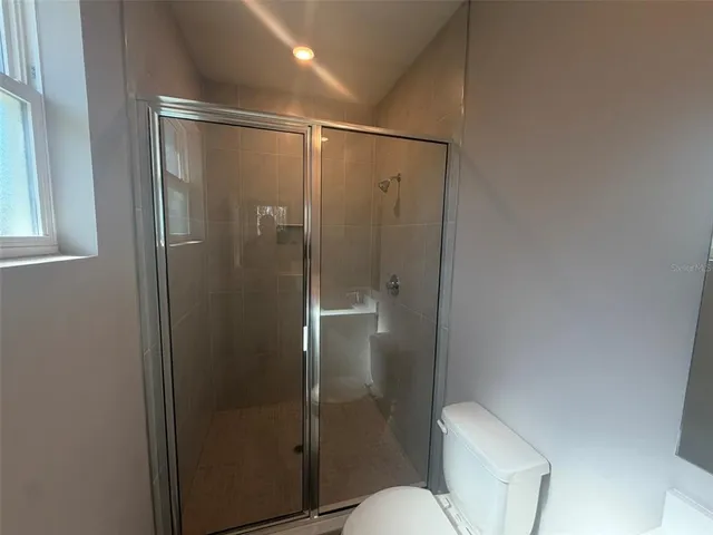 a bathroom with a double vanity sink a toilet and a mirror