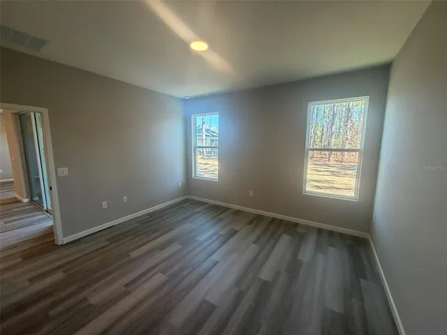 a view of kitchen view wooden floor and stainless steel appliances