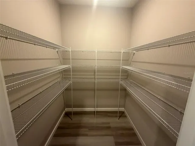 a kitchen with a sink a counter space and wooden floor