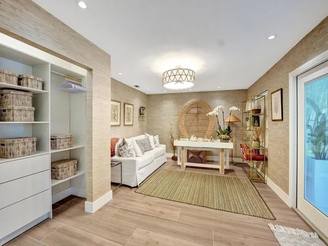 a dining room with furniture a chandelier and a floor to ceiling window