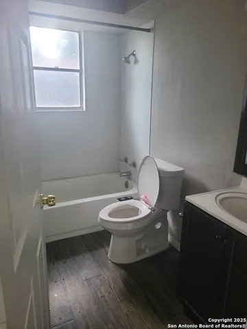 a bathroom with a toilet a sink and bathtub