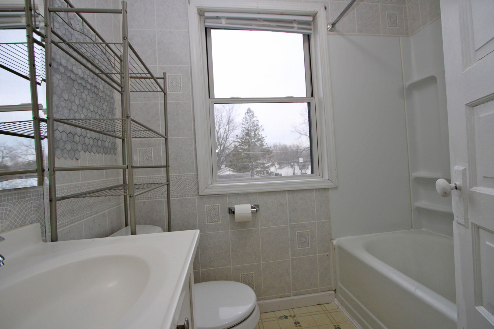3013 Elim Avenue Zion, IL 60099 - Photo 29 of 36 a bathroom with a toilet a bath tub and a window