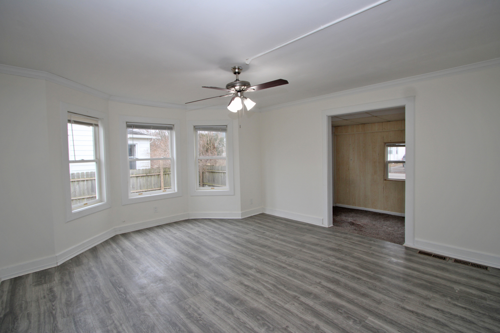 3013 Elim Avenue Zion, IL 60099 - Photo 6 of 36 a view of an empty room with a window and wooden floor
