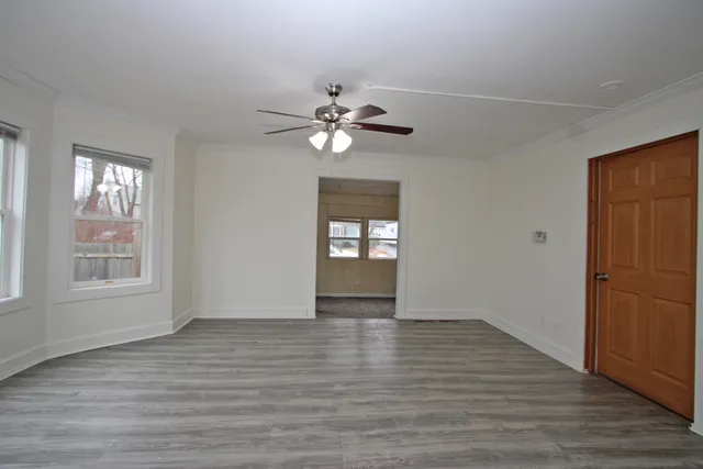 wooden floor in an empty room with a window