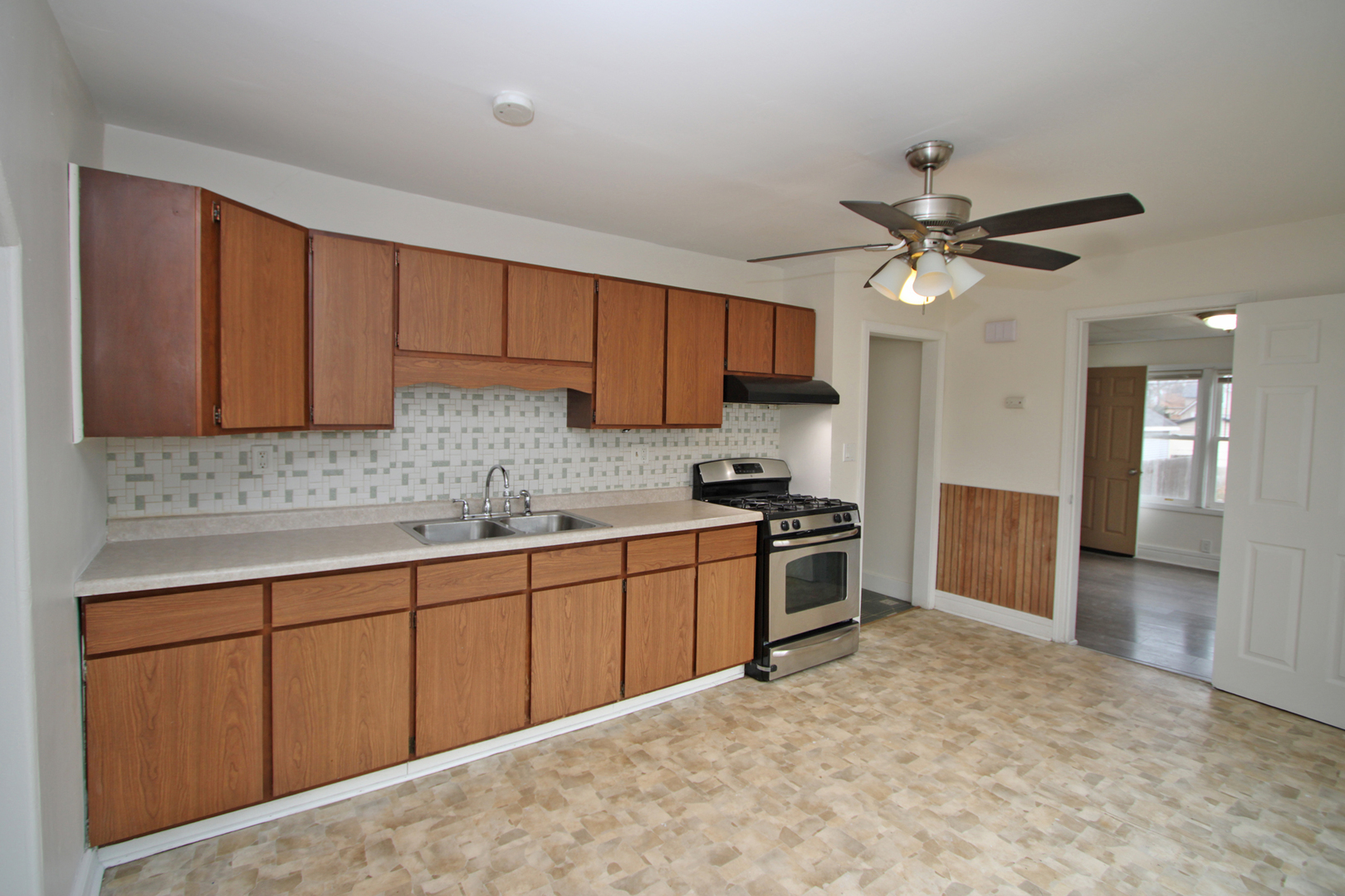 3013 Elim Avenue Zion, IL 60099 - Photo 10 of 36 a kitchen with stainless steel appliances granite countertop a stove sink and cabinets