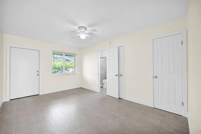 an empty room with windows and closet