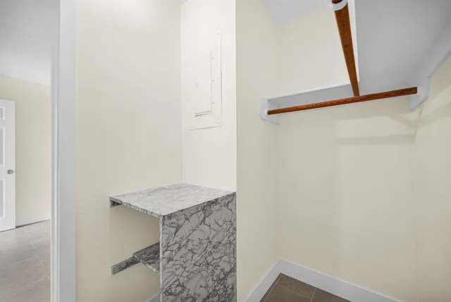 a bathroom with a granite countertop shower and a sink