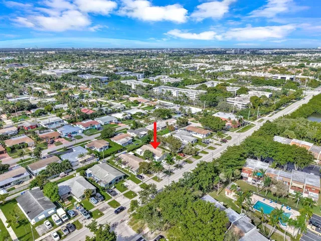 an aerial view of residential building with green space