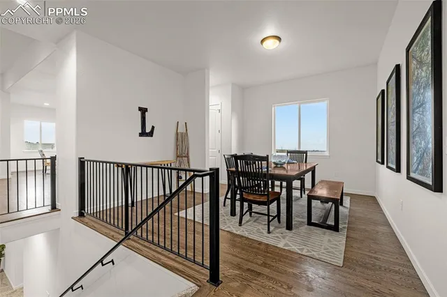 a view of a a dining room with furniture window and wooden floor