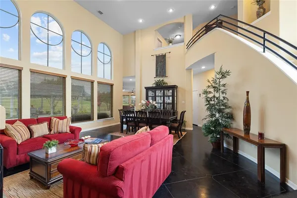 a living room with furniture fireplace and a large window