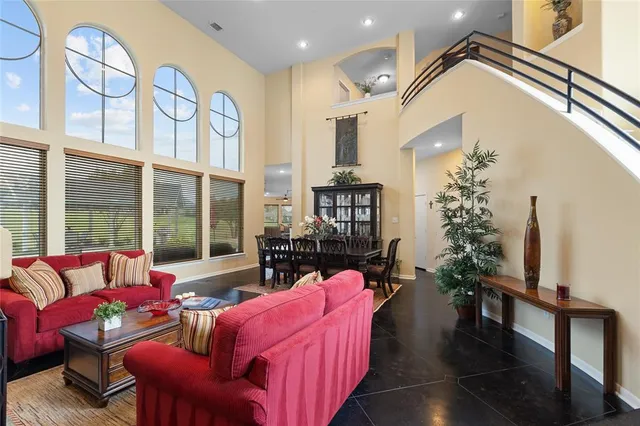 a living room with furniture fireplace and a large window