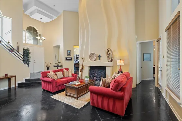 a living room with furniture fireplace and a large mirror