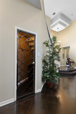 a living room with a potted plant on a table and a potted plant