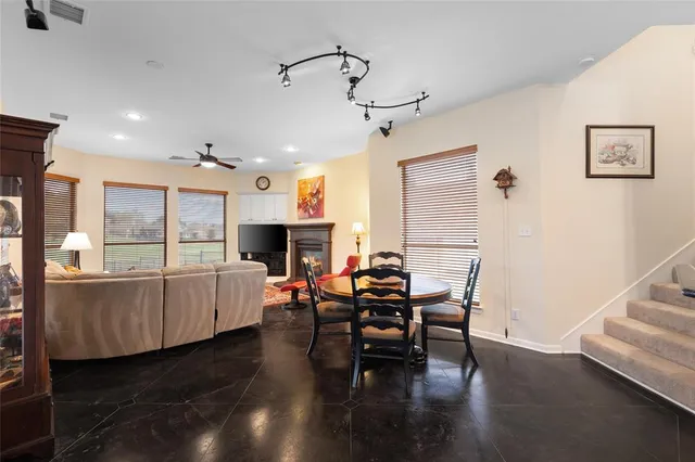 a living room with furniture a fireplace and a table