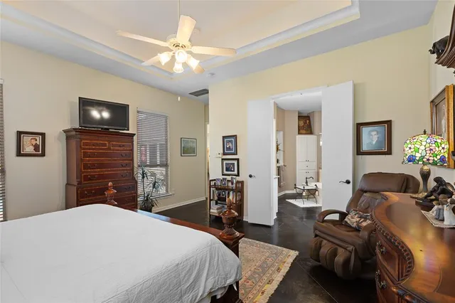 a bedroom with a bed and a chandelier