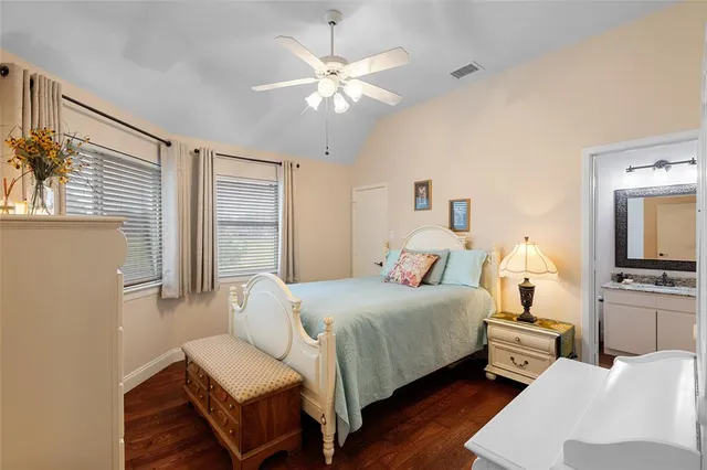 a bedroom with a bed wooden floor and window