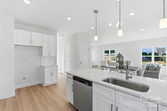 a kitchen with a sink appliances and cabinets