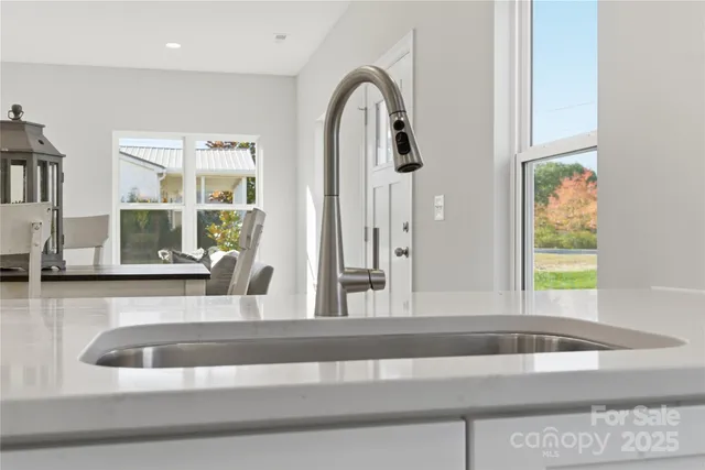a view of kitchen with a sink and a large window