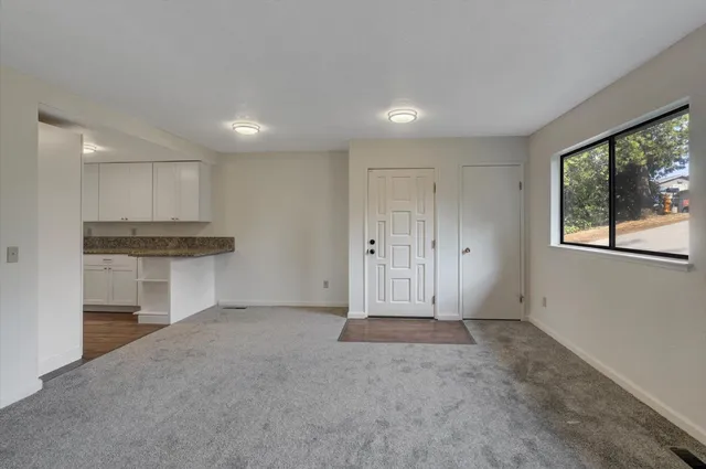 a kitchen with granite countertop stainless steel appliances a stove sink and microwave