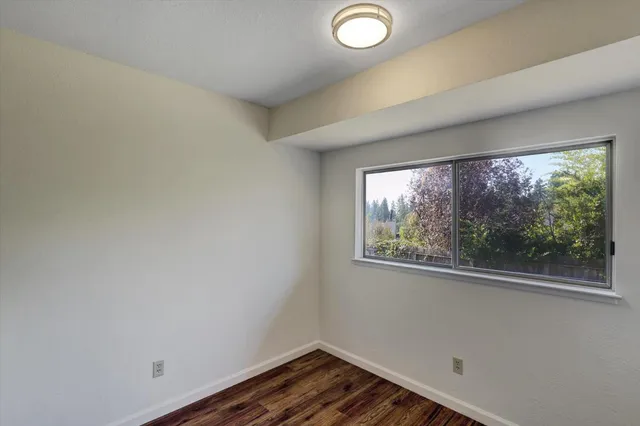 a bathroom with a granite countertop sink a mirror and a shower