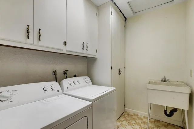 a view of an empty room with wooden floor and window