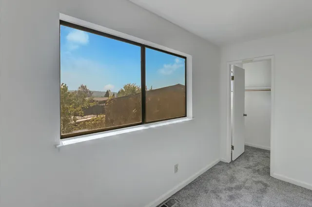 a view of a room with a wooden door
