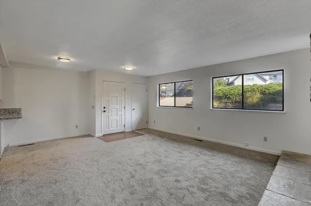 a view of a kitchen with wooden floor and a sink
