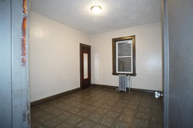 an empty room with windows and closet