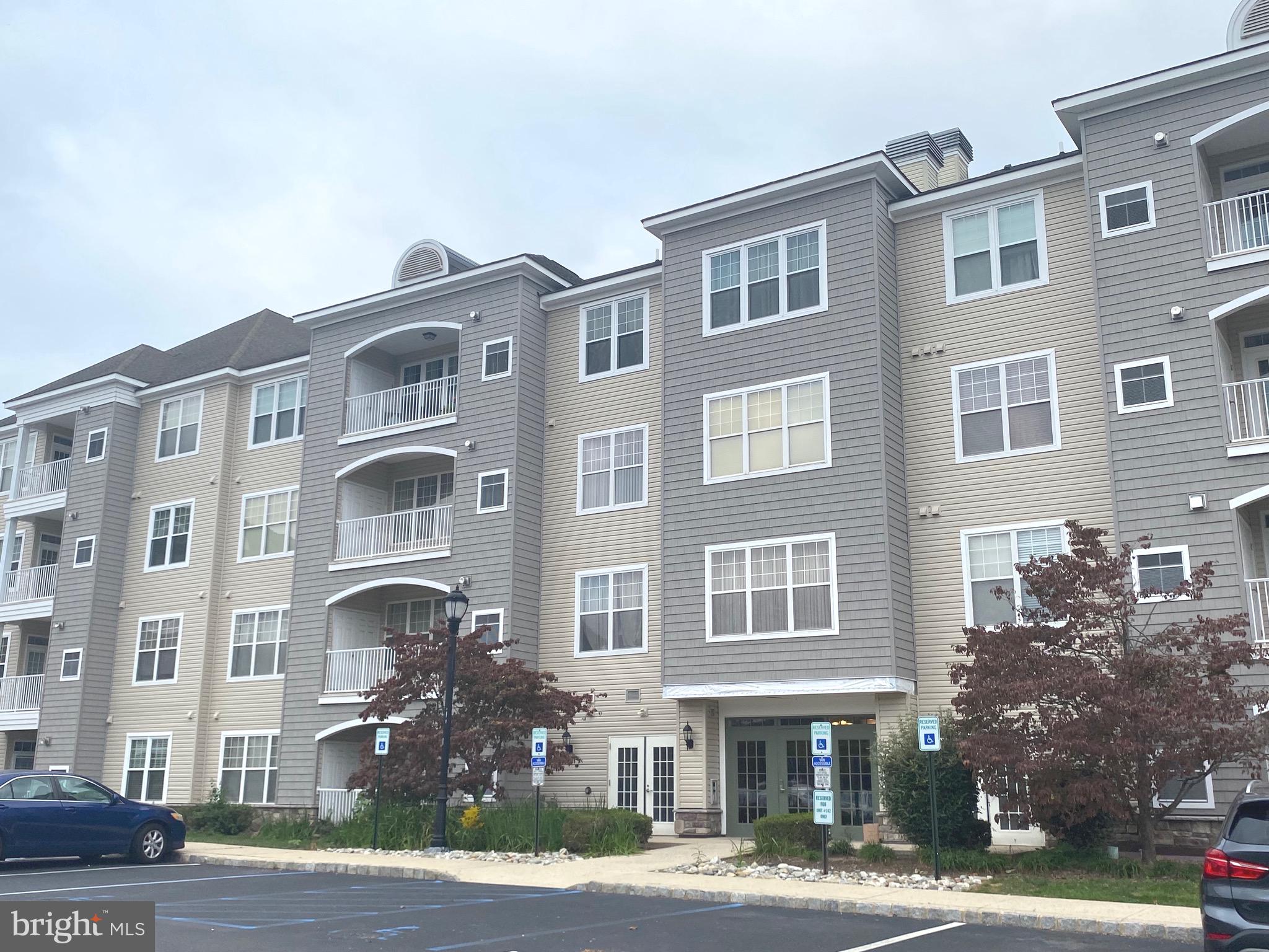 326 Masterson Court Ewing, NJ 08618 - Photo 1 of 17 a front view of a building with lot of windows