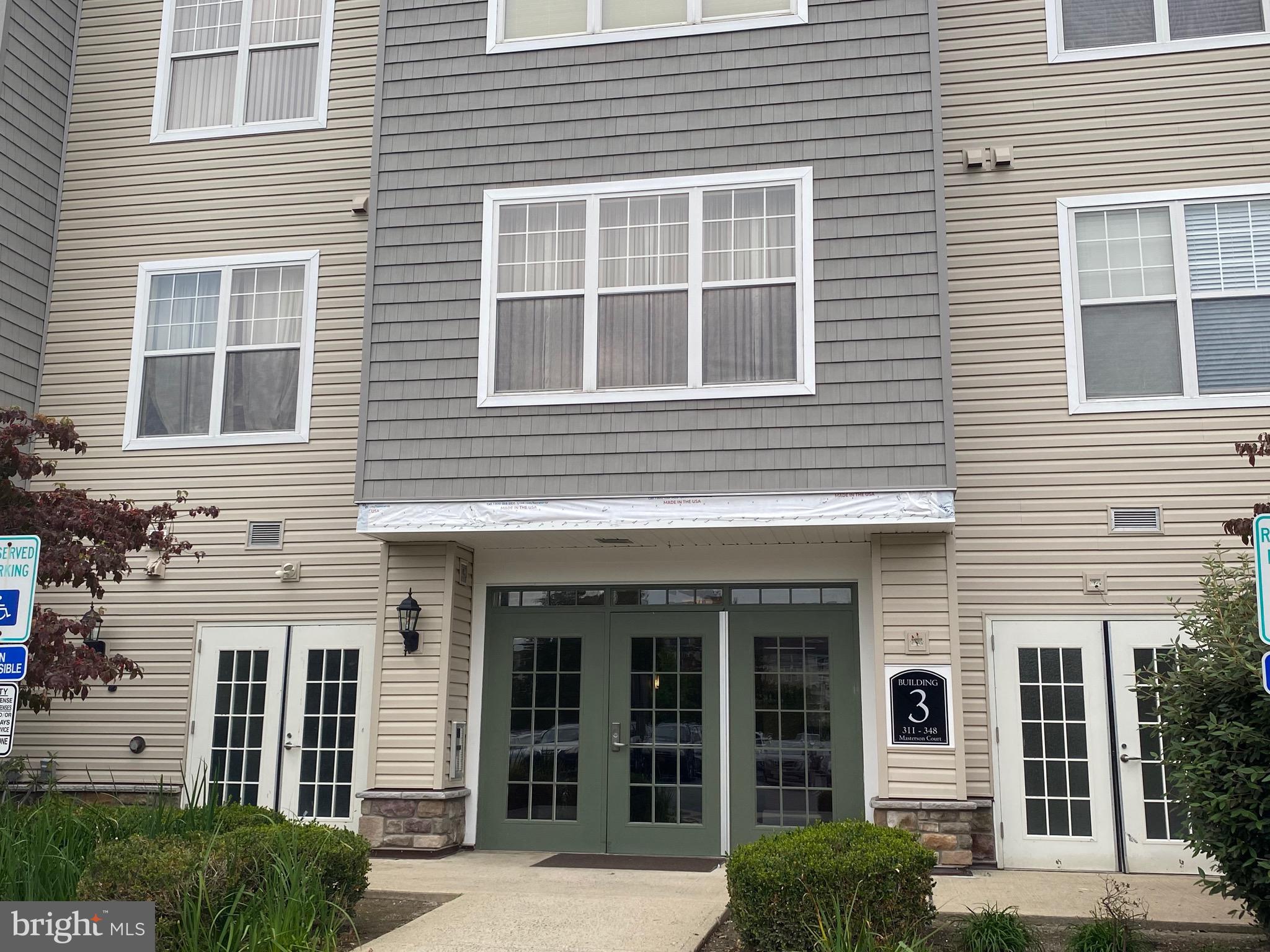 326 Masterson Court Ewing, NJ 08618 - Photo 17 of 17 a view of a house with large windows and a yard