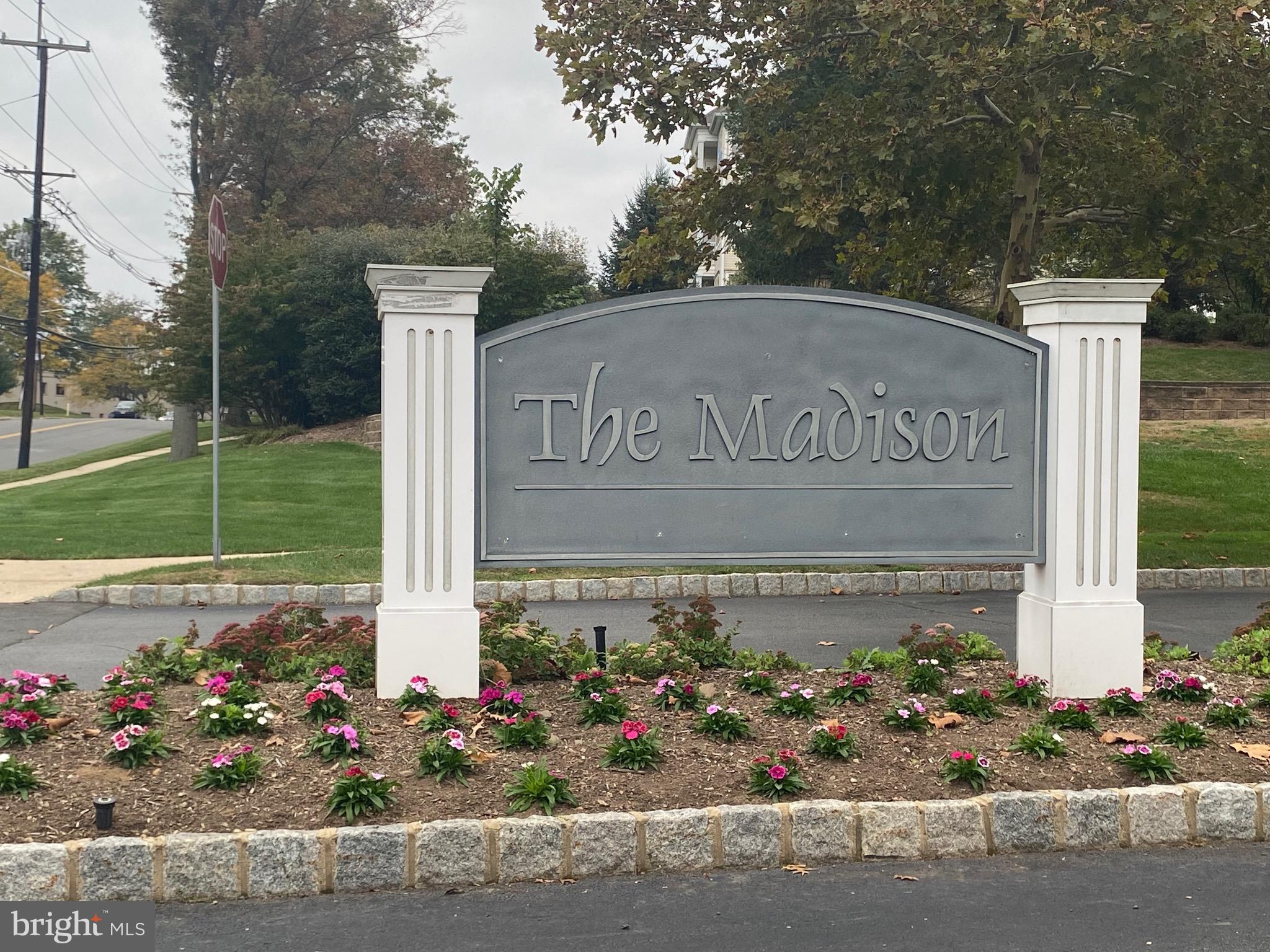 326 Masterson Court Ewing, NJ 08618 - Photo 2 of 17 a sign that is in front of flowers
