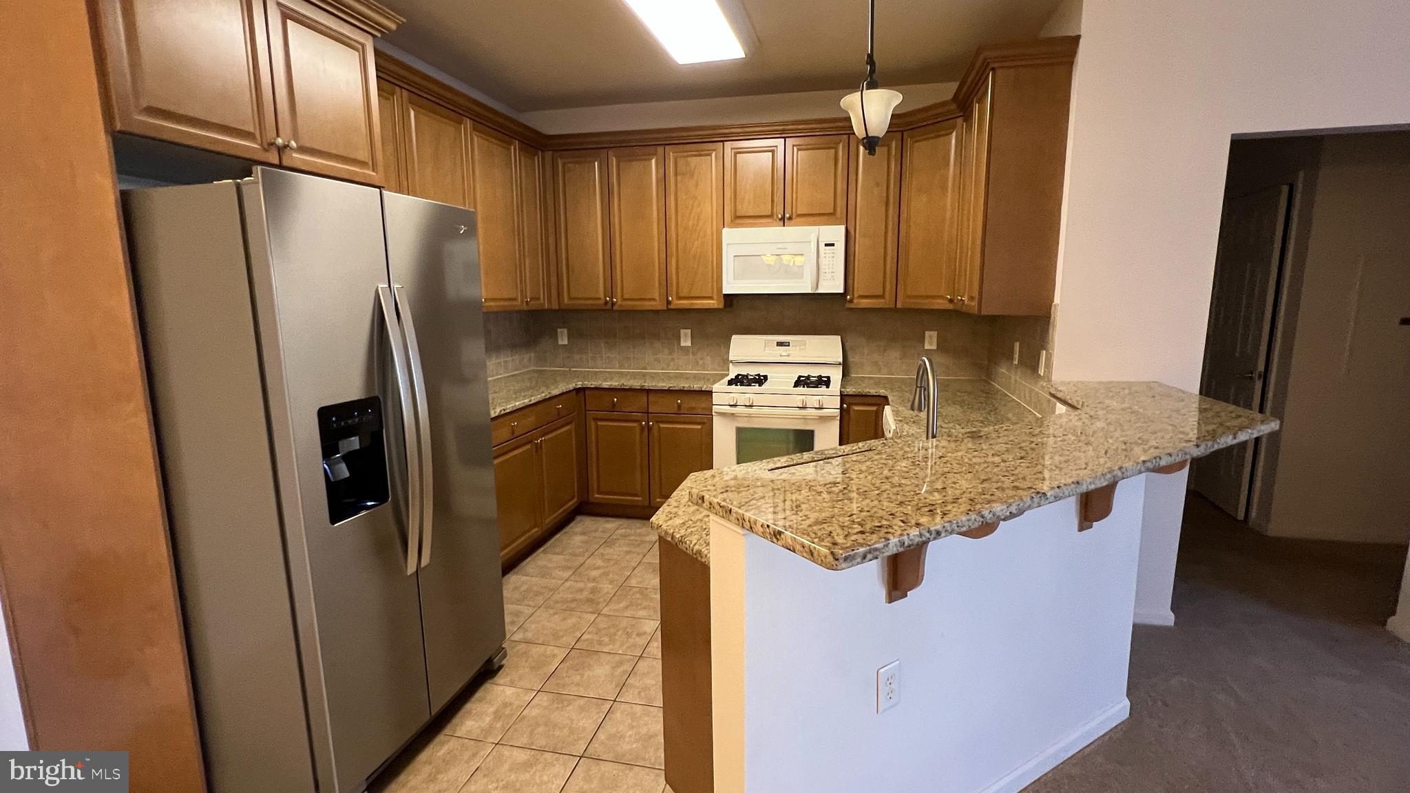 326 Masterson Court Ewing, NJ 08618 - Photo 3 of 17 a kitchen with stainless steel appliances granite countertop a refrigerator a sink and a refrigerator